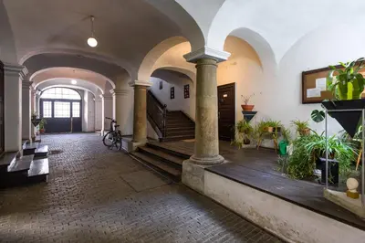 a large room with a staircase and some plants at LUXURY Apartment at the Main Square in Kraków