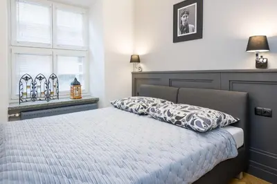 a bedroom with a bed with a pillow on it at LUXURY Apartment at the Main Square in Kraków