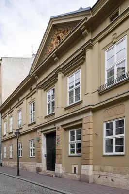 a large yellow building with a door on a street at LUXURY Apartment at the Main Square Tomasza street in Kraków