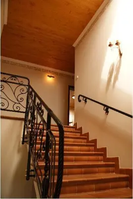 a staircase in a building with a black railing at A-Prim in Oświęcim