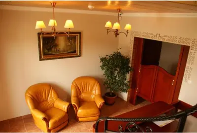 a living room with two chairs and a mirror at A-Prim in Oświęcim