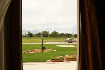 a window view of a park with a car parked in a driveway at A-Prim in Oświęcim