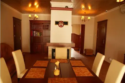 a dining room with a table and white chairs at A-Prim in Oświęcim
