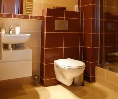 a bathroom with a toilet and a sink at A-Prim in Oświęcim