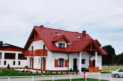 a large white house with a red roof at A-Prim in Oświęcim