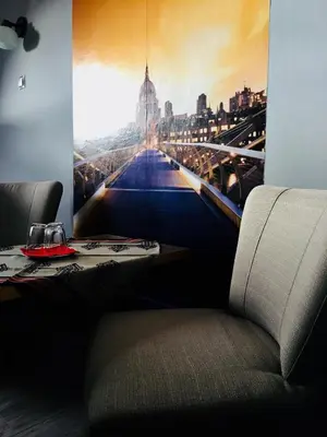 a dining room with a table and a picture of a city at Hotel Restauracja U Guta in Klikuszowa