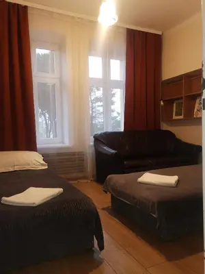a living room with two beds and a couch at Hostel Retro in Kraków