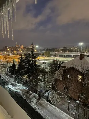 a view of a city at night with snow on the ground at Hostel Retro in Kraków