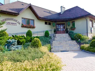 a house with a staircase leading to the front door at Hotel Kochanów in Kochanów
