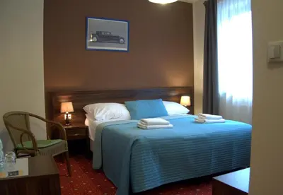 a hotel room with a bed with towels on it at Hotel Kochanów in Kochanów