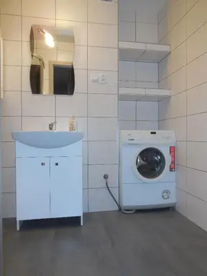 a bathroom with a washing machine and a sink at Pokoje Gościnne in Kraków