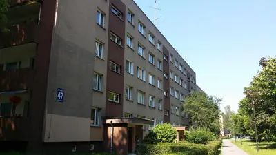 an apartment building with a sidewalk next to it at Pokoje Gościnne in Kraków