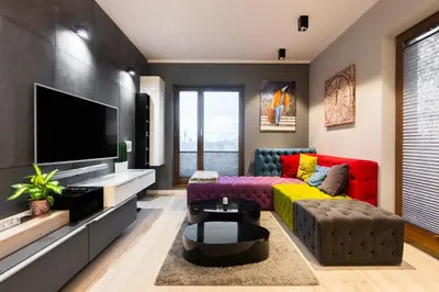 a living room with a couch and a tv at Elegant Business Accommodation with Parking - by Upstairs in Kraków