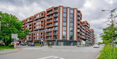 a large brick building on a city street at InPoint Zablocie Modern Apartments for Work&Travel Self Check-in in Kraków