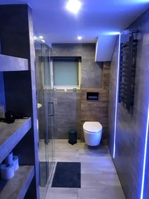 a bathroom with a toilet and a glass shower at FANTAZJA in Spytkowice