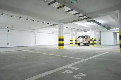an empty parking lot with a car parked in it at 3D KOSCIUSZKI 19 Apartament in Kraków