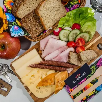 a plate of food with bread and vegetables on a table at 3D KOSCIUSZKI 19 Apartament in Kraków