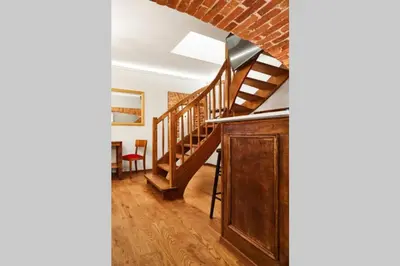 a room with a staircase and a brick wall at HOUSEHOST Apartment II: Studencka Street in Kraków