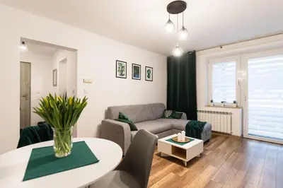 a living room with a couch and a table at Szmaragd in Rabka