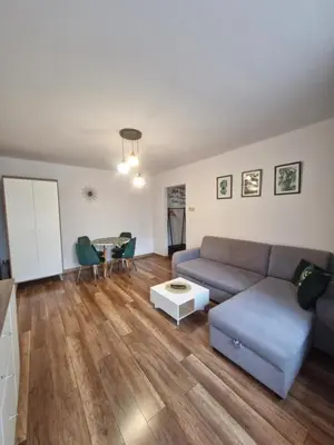 a living room with a couch and a table at Szmaragd in Rabka