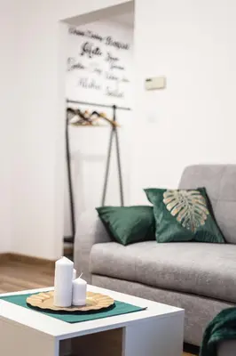 a living room with a couch and a coffee table at Szmaragd in Rabka