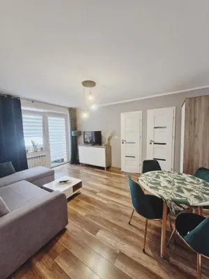 a living room with a couch and a table at Szmaragd in Rabka