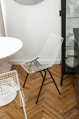 a white chair and a table in a room at Wesoła by Landmark Apartments in Kraków