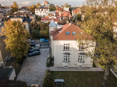 an aerial view of a white house in a city at Wesoła by Landmark Apartments in Kraków