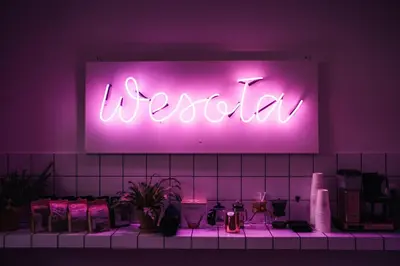 a neon sign that says usoria on a wall at Wesoła by Landmark Apartments in Kraków