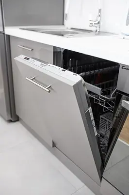a dishwasher with its door open in a kitchen at Native Apartments Blich 7 in Kraków