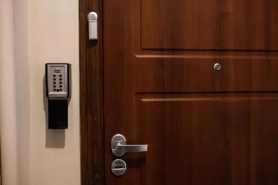 a wooden door with a phone attached to it at Native Apartments Blich 7 in Kraków