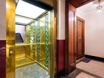 a hallway with a glass door and stairs at CracWoW St. Thomas Apartment in Kraków
