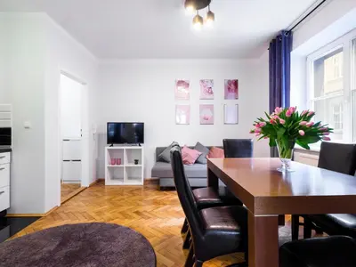 a living room with a table and a couch at CracWoW St. Thomas Apartment in Kraków
