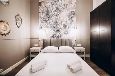 a bedroom with a bed with two shoes on it at Native Apartments Paulińska 20 in Kraków