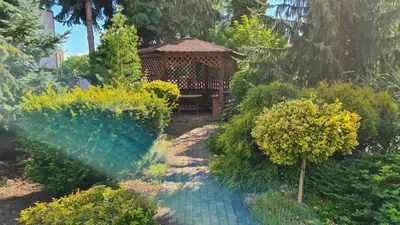 a gazebo in the middle of a garden at Apartament DeLuxe 1 in Oświęcim