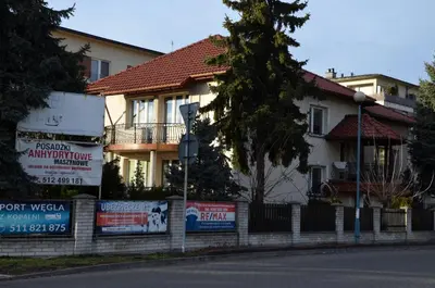 a house with signs on the side of a street at Apartament DeLuxe 1 in Oświęcim