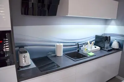 a kitchen with a counter top with a sink at Apartament DeLuxe 1 in Oświęcim