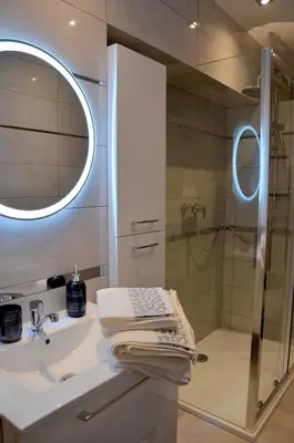 a bathroom with a sink and a shower at Apartament DeLuxe 1 in Oświęcim
