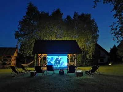 a gazebo with chairs and a large screen at Zacisze in Morawica