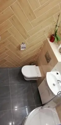 a bathroom with a white toilet and a sink at Lion Apartment in Andrychów