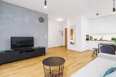 a living room with a flat screen tv on a wall at Apartments Supernova near Tauron Arena by Noclegi Renters in Kraków