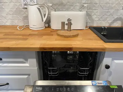 a kitchen counter top with a sink and a dishwasher at Apartamenty Centrum in Andrychów