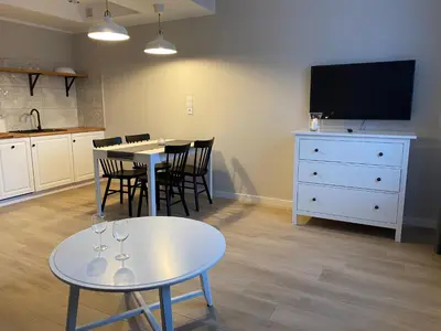 a dining room with two tables and a tv at Apartamenty Centrum in Andrychów