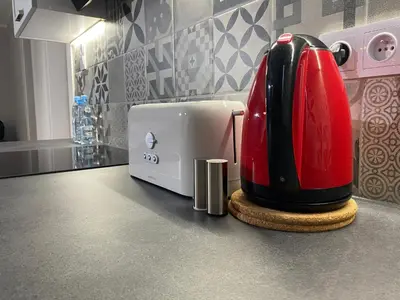 a kitchen with a red and white appliance on a counter at Apartamenty Centrum in Andrychów