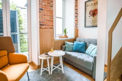 a living room with a couch and a table at Tower Street Apartments in Kraków