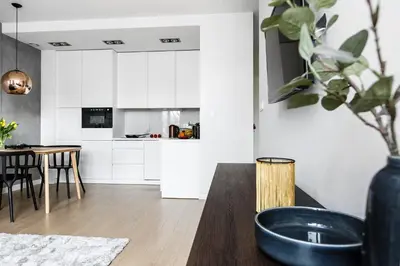 a kitchen and dining room with a black bowl on a table at Otium Old Town Harmonica in Kraków