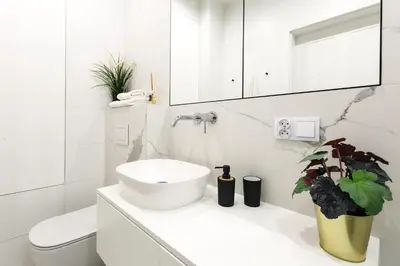 a white bathroom with a sink and a toilet at Otium Old Town Harmonica in Kraków