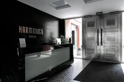 a lobby with a glass counter in front of a door at Otium Old Town Harmonica in Kraków