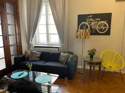 a living room with a couch and a table at Floriańska Grand Apartment 2 in Kraków