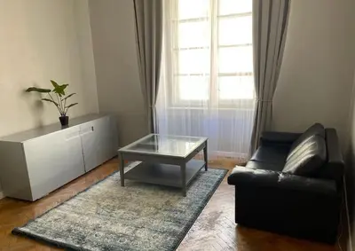 a living room with a couch and a coffee table at Floriańska Grand Apartment 2 in Kraków